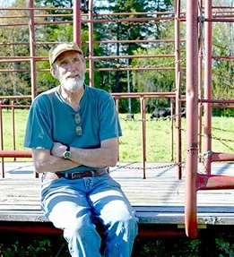 Logan Johnston sits in scaffolding