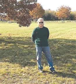 Randy Dondero standing in a field.