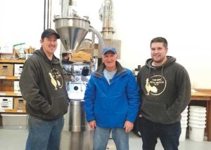 Andrew Newell, owner of Farmhouse Coffee Roasters, with his father Michael Newell and employee Garrett Greystone. Photo courtesy of Andrew Newell