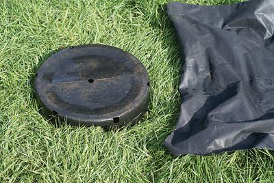 A bokashi drain pan made from the bottom of a large nursery pot and plastic landscape cloth