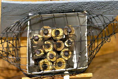 Fig. 1. Twig tubes with paper liners in a cardboard milk carton covered with a cedar shingle and protected from birds with wire mesh.