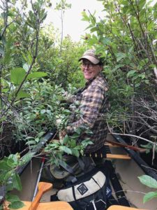 Selene Frohmberg looking for bumble bees from the bow of a canoe. Photo by Eric Frohmberg