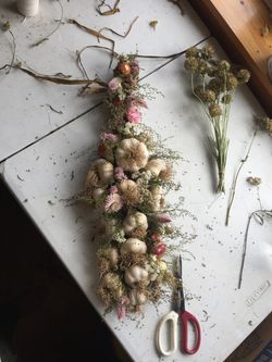 Garlic braid adorned with dried flowers