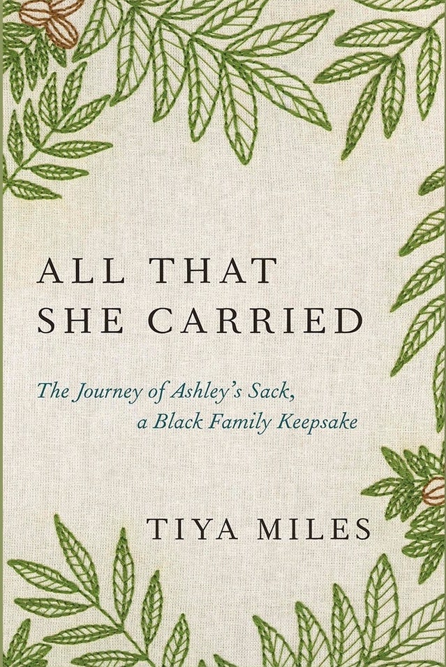 Book cover with green leaves hemming the title "All That She Carried"