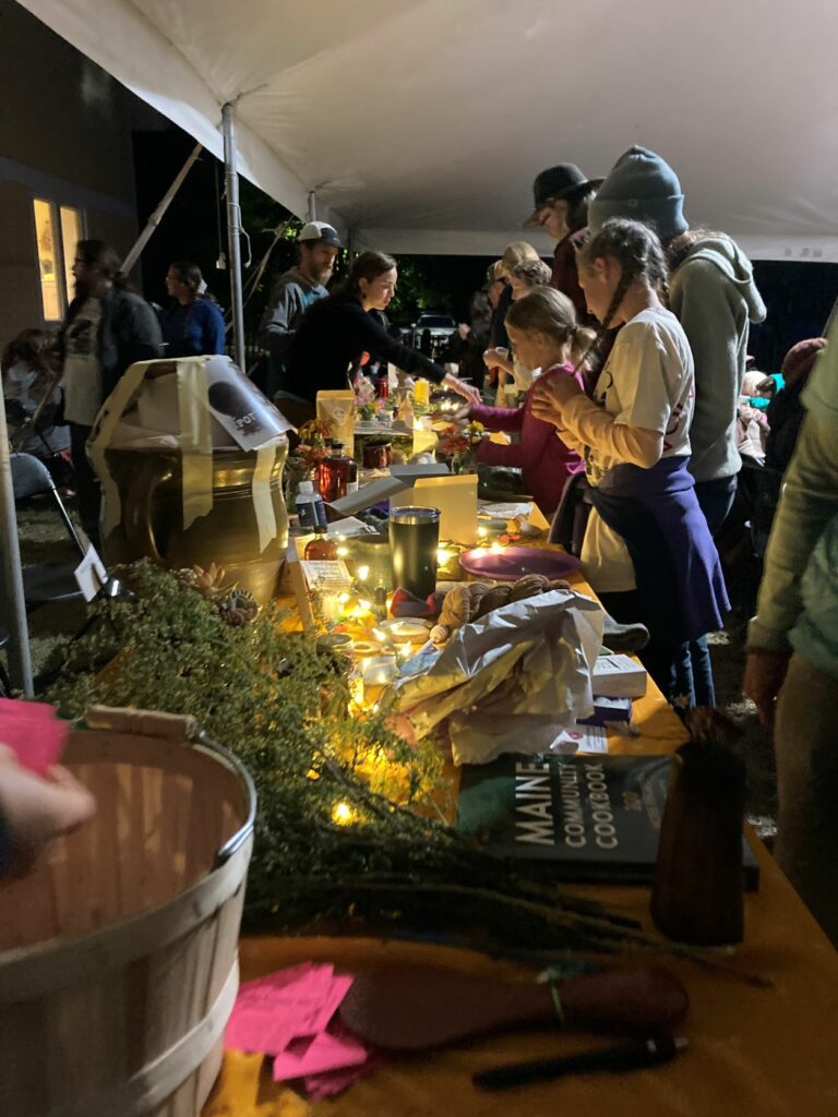 Volunteers line up at a table with gifts.