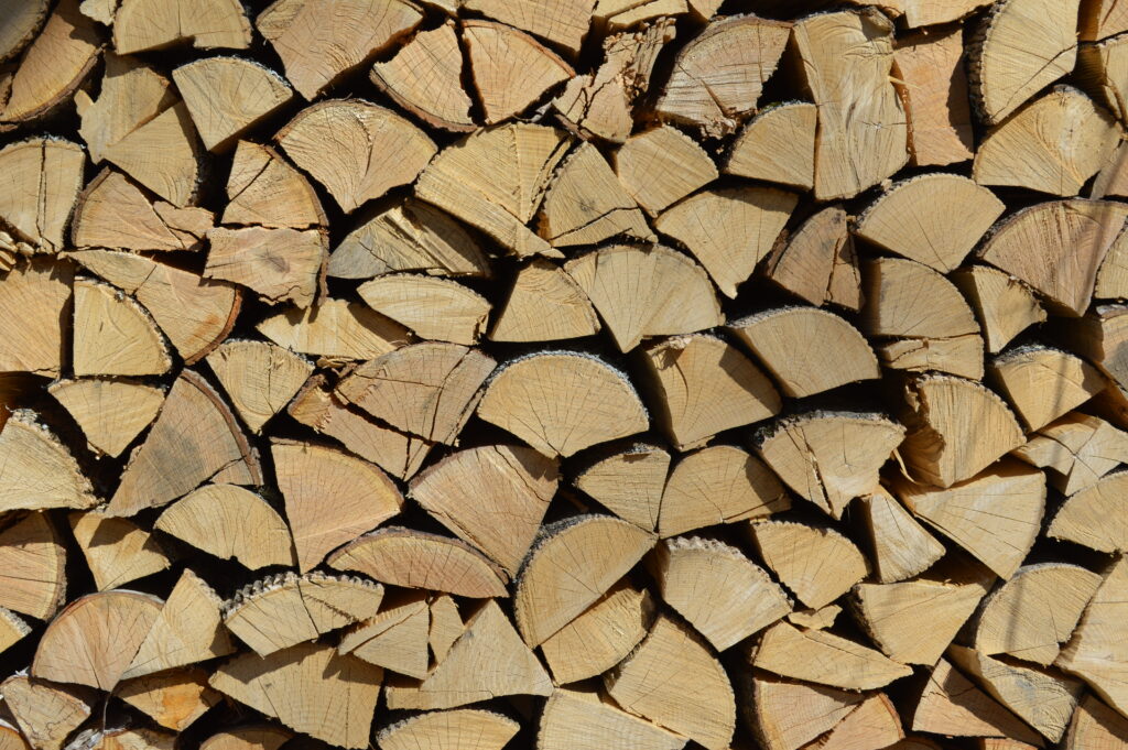 Image features a stack of cordwood