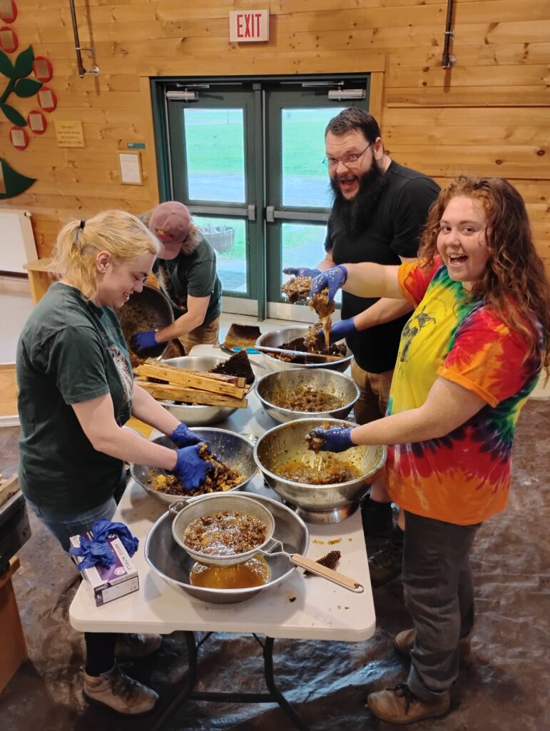 Earth Day volunteers processing honey