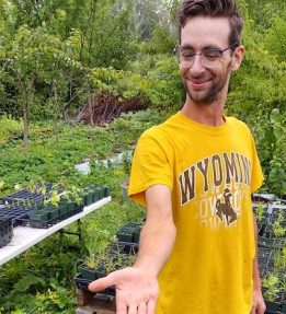 A person shows of seedling trays.